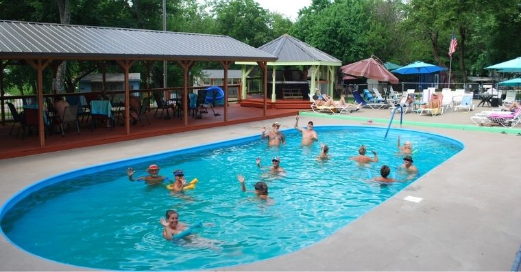 group of nudists having fun in the Prairie Haven Nudist Park pool